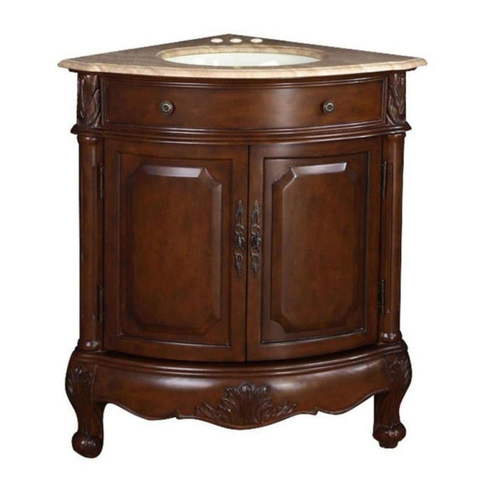 Corner bathroom vanity in rich dark wood with curved cabinet doors and ornate carved details, topped with beige marble and oval undermount sink.