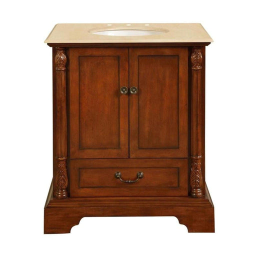 Traditional wooden bathroom vanity with rich brown finish, decorative columns, and cream marble top with oval sink.