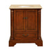 Traditional wooden bathroom vanity with rich brown finish, decorative columns, and cream marble top with oval sink.