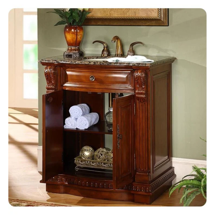 Rich wood bathroom vanity with marble top, rolled white towels, bronze faucet, and decorative golden spheres on shelves.