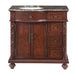 Rich mahogany bathroom vanity with marble top, ornate carved details, two-door cabinet, and four drawers on decorative bun feet.