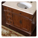Rich wood bathroom vanity with ornate carved details, white marble top, and inset oval sink