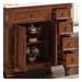 Ornate wooden cabinet with decorative drawers, open door revealing antique golden urn and ornamental spheres on shelves.