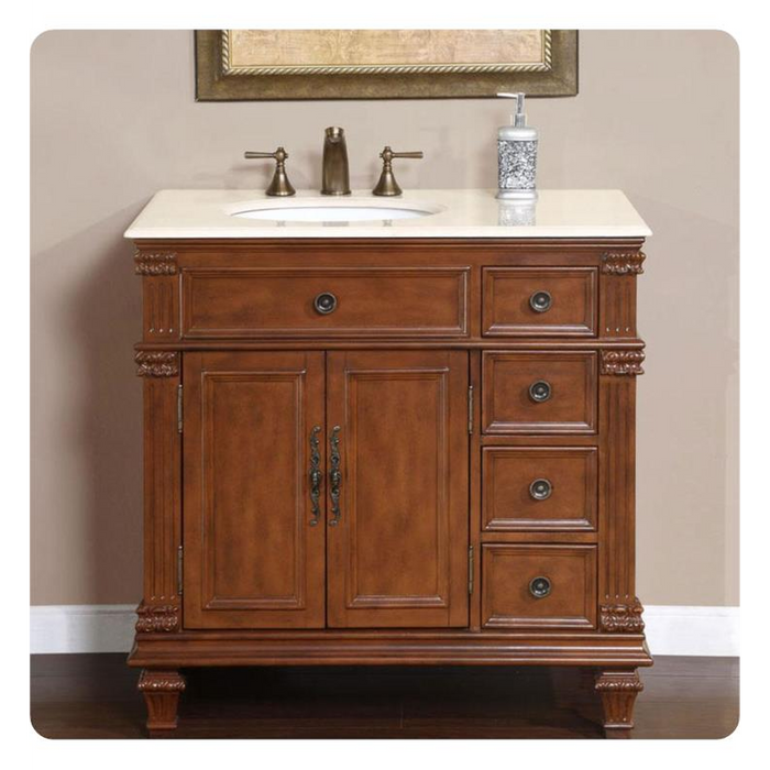 Traditional wood bathroom vanity with white marble top, bronze faucet, and decorative carved details