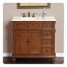 Traditional wood bathroom vanity with white marble top, bronze faucet, and decorative carved details