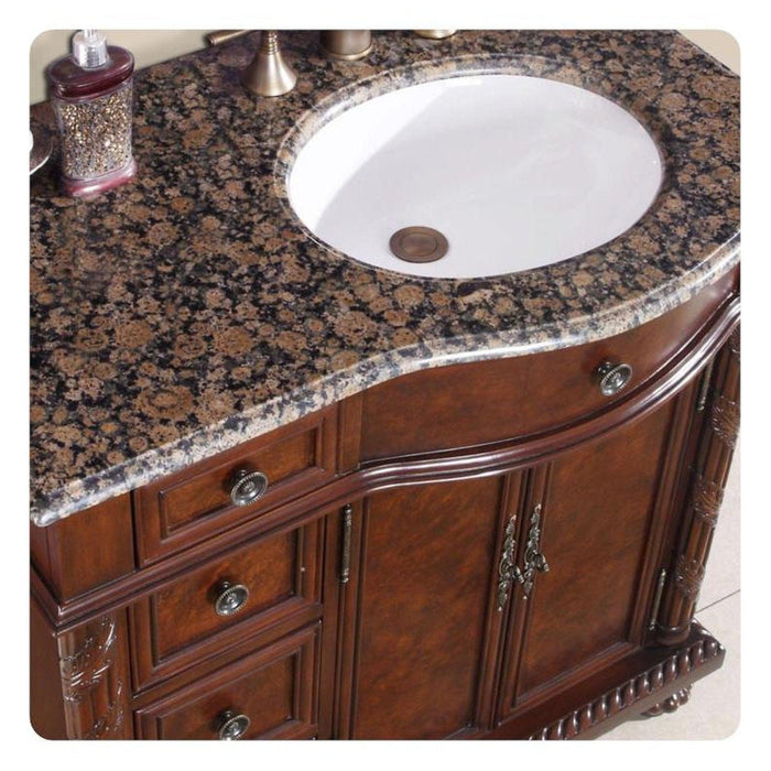 Rich wood bathroom vanity with Baltic brown granite countertop and white undermount sink