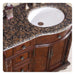 Rich wood bathroom vanity with Baltic brown granite countertop and white undermount sink
