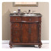 Ornate wooden bathroom vanity with marble top, three drawers, center cabinet doors, and brushed nickel faucet