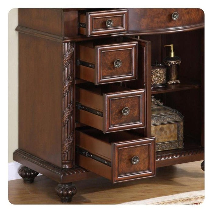 Ornate wooden side table with three open drawers, decorative carved details, and round brass drawer pulls, sitting on carved bun feet.