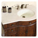 Rich wood bathroom vanity with white countertop, oval sink, and bronze faucet fixtures. Decorative mosaic soap dispenser and toothbrush holder complete the elegant bathroom setup.