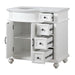 White bathroom vanity with four open drawers, one cabinet door, and decorative turned legs