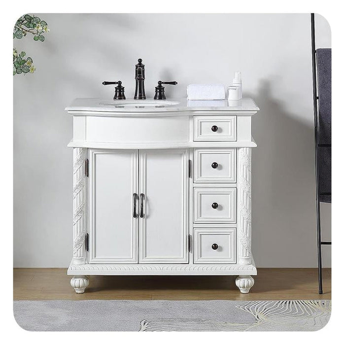 White bathroom vanity with black fixtures, ornate carved details, and four drawers on right side
