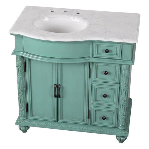 Mint green bathroom vanity with white marble top, two cabinet doors, and four decorative drawers with black knobs.
