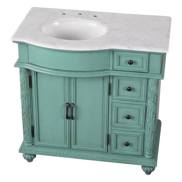 Mint green bathroom vanity with white marble top, two cabinet doors, and four decorative drawers with black knobs.