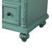 Vintage sage green dresser with ornate carved details, decorative drawer pull, and curved bun feet.