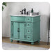 Vintage-style turquoise bathroom vanity with white marble top, black faucet, and three drawers on ornate bun feet.