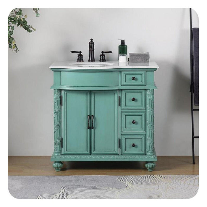 Vintage-style turquoise bathroom vanity with white marble top, black faucet, and decorative carved details