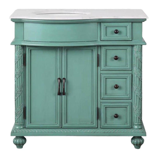 Vintage-style teal bathroom vanity with carved details, white marble top, double doors, and four drawers on ornate bun feet.
