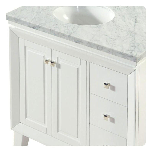 White bathroom vanity with marble top, two doors, two drawers, and silver hardware.