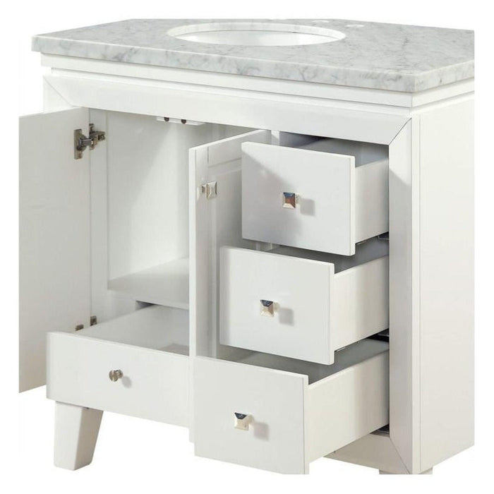 White bathroom vanity with marble top, open cabinet door, and three pullout drawers with small metallic knobs.