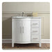 White bathroom vanity with marble countertop, curved cabinet doors, three drawers, and silver faucet against neutral wall.