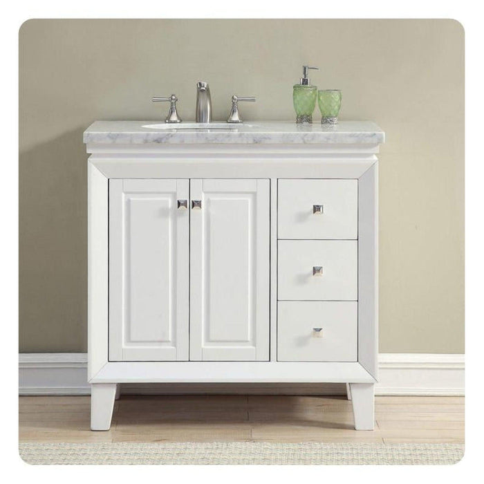 White bathroom vanity with marble countertop, two cabinet doors, three drawers, silver faucet, and green soap dispensers.