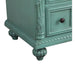 Vintage sage green wooden drawer with ornate carved details, dark round knob, and decorative bun feet.