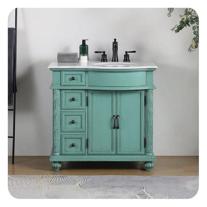 Mint green bathroom vanity with white marble top, three drawers, double doors, and black fixtures on a textured rug.
