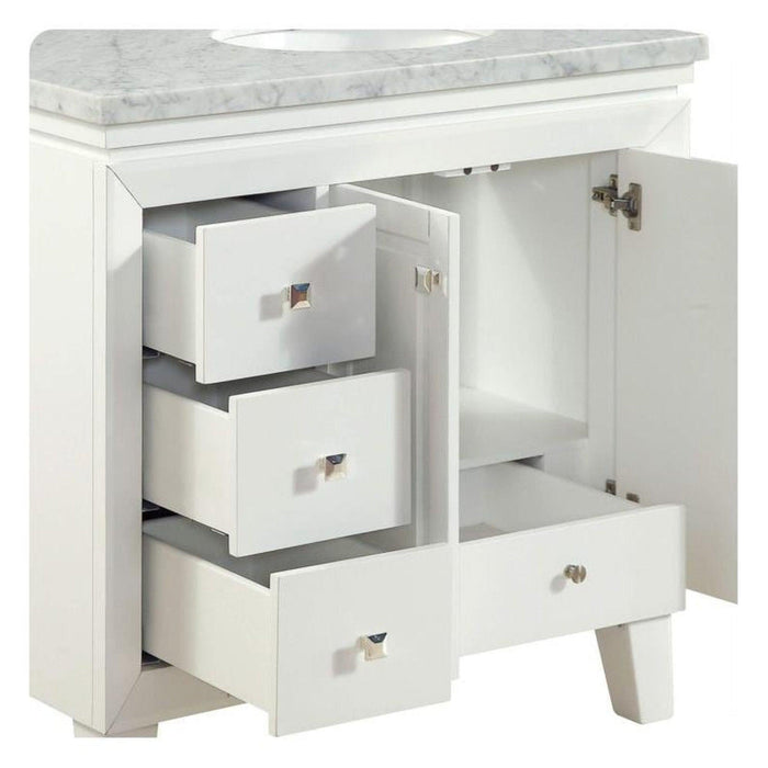 White bathroom vanity with marble top, featuring three drawers and an open cabinet side, with delicate silver hardware.