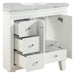 White bathroom vanity with marble top, featuring three drawers and an open cabinet side, with delicate silver hardware.