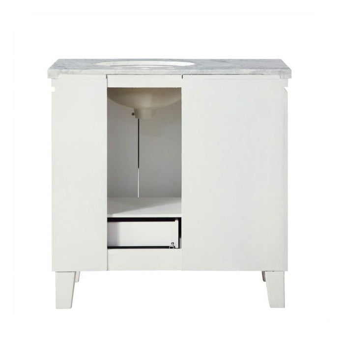 White bathroom vanity with marble top, open cabinet door revealing interior storage space and a small drawer.