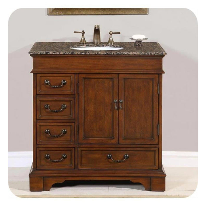 Traditional wooden bathroom vanity with marble top, undermount sink, and brushed nickel faucet; four drawers and double cabinet doors.