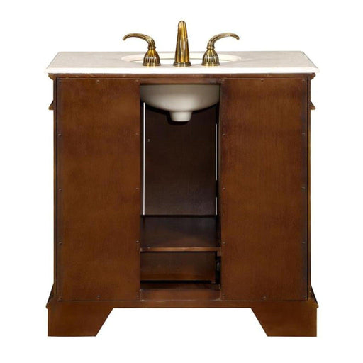 Rich wood bathroom vanity with white marble top and gold-toned faucet fixtures, featuring cabinet storage underneath.