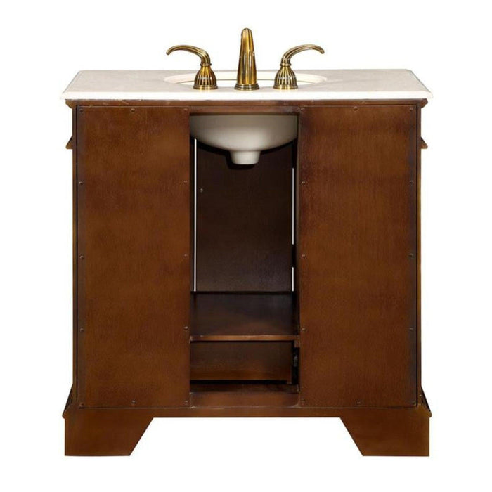 Rich wood bathroom vanity with white marble top and gold-toned faucet fixtures, featuring cabinet storage underneath.