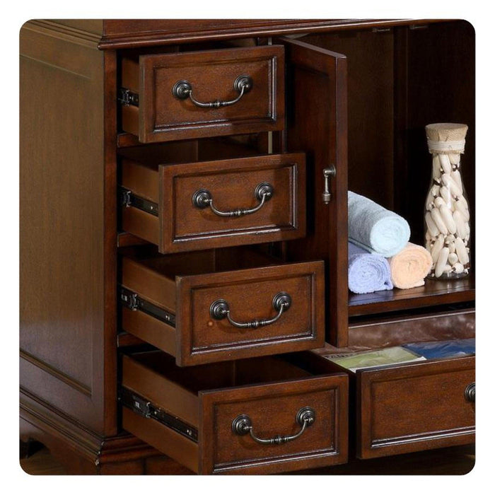Wooden dresser with four open drawers, antique bronze handles, rolled towels, and decorative vase on side shelf.