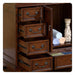 Wooden dresser with four open drawers, antique bronze handles, rolled towels, and decorative vase on side shelf.