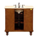 Wooden bathroom vanity with marble top, white sink, and brushed nickel faucet and hardware, featuring turned legs and open storage compartment.