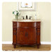 Elegant cherry wood bathroom vanity with curved design, marble top, dark fixtures, and white hydrangeas in a green vase.