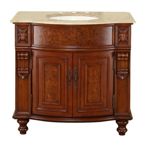 Ornate wooden bathroom vanity with curved front, carved details, and beige marble top with oval sink