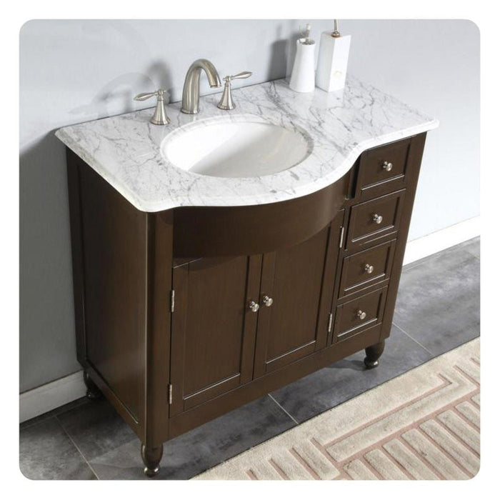 Dark brown bathroom vanity with white marble top and oval undermount sink, brushed nickel faucet