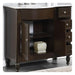 Dark wood bathroom vanity with marble top, open cabinet door revealing decorative ceramic container on lower shelf