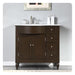 Dark wood bathroom vanity with white marble top, chrome faucet, and four drawers on right side.