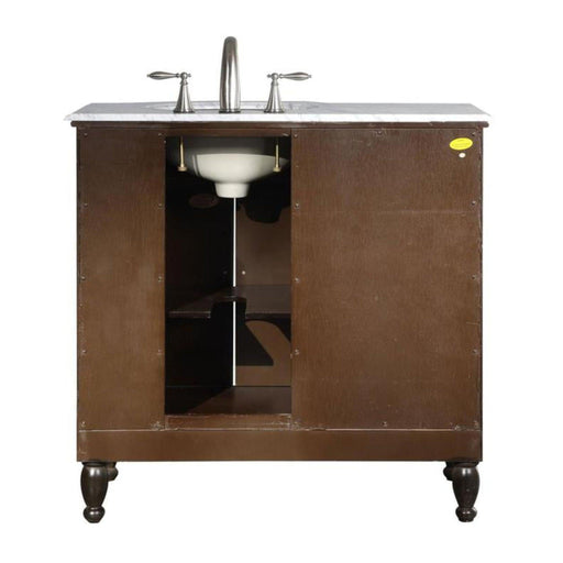 Dark brown bathroom vanity with white marble top, chrome faucet, and open cabinet revealing interior shelving and white sink basin.