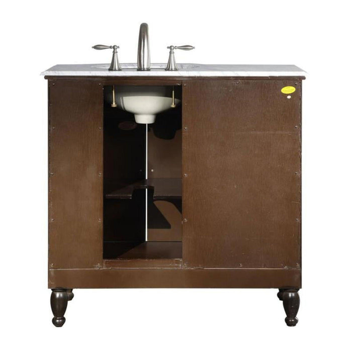 Dark brown bathroom vanity with white marble top, chrome faucet, and open cabinet revealing interior shelving and white sink basin.