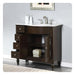 Dark wood bathroom vanity with white marble top, brushed nickel faucet, and open shelving with decorative accent.