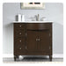Dark wood bathroom vanity with white marble countertop, four drawers, cabinet, and silver faucet fixtures