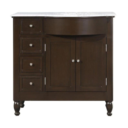 Dark wood bathroom vanity with white marble top, four drawers on left, double cabinet doors on right, and turned legs