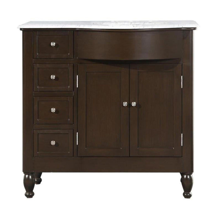 Dark wood bathroom vanity with white marble top, four drawers on left, double cabinet doors on right, and turned legs