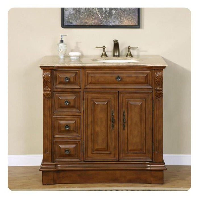Rich wood bathroom vanity with marble top, three drawers, two cabinet doors, and bronze faucet fixtures