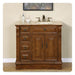 Rich wood bathroom vanity with marble top, three drawers, two cabinet doors, and bronze faucet fixtures